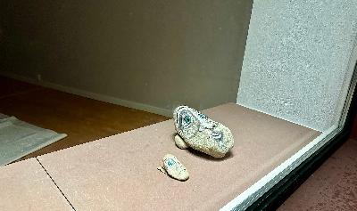 A Solitary Runner Carries a Stone Through the Countryside