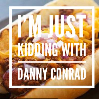 Sucking on a Chili Dog, while wearing a Mask.