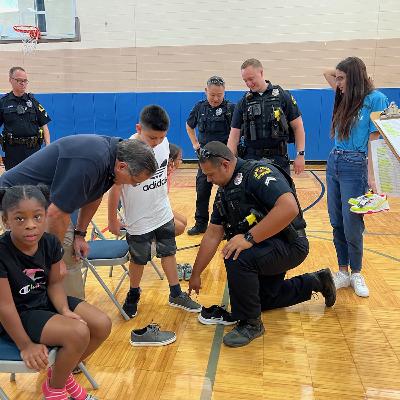 Caring Cops gift new shoes to grateful children