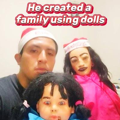 Man makes a family out of dolls.