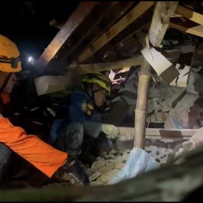 Rescue teams search at scene of Indonesia landslide